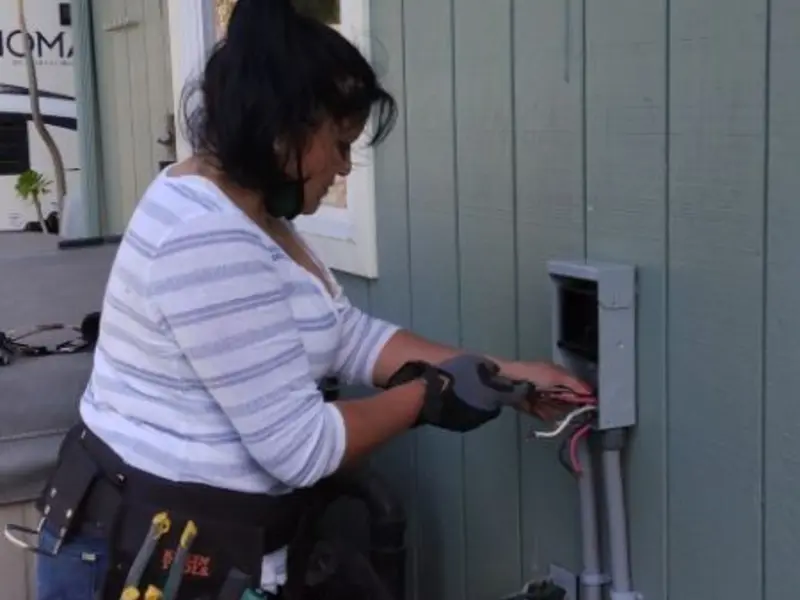 Licensed electrician wiring an exterior subpanel in Camp Swift