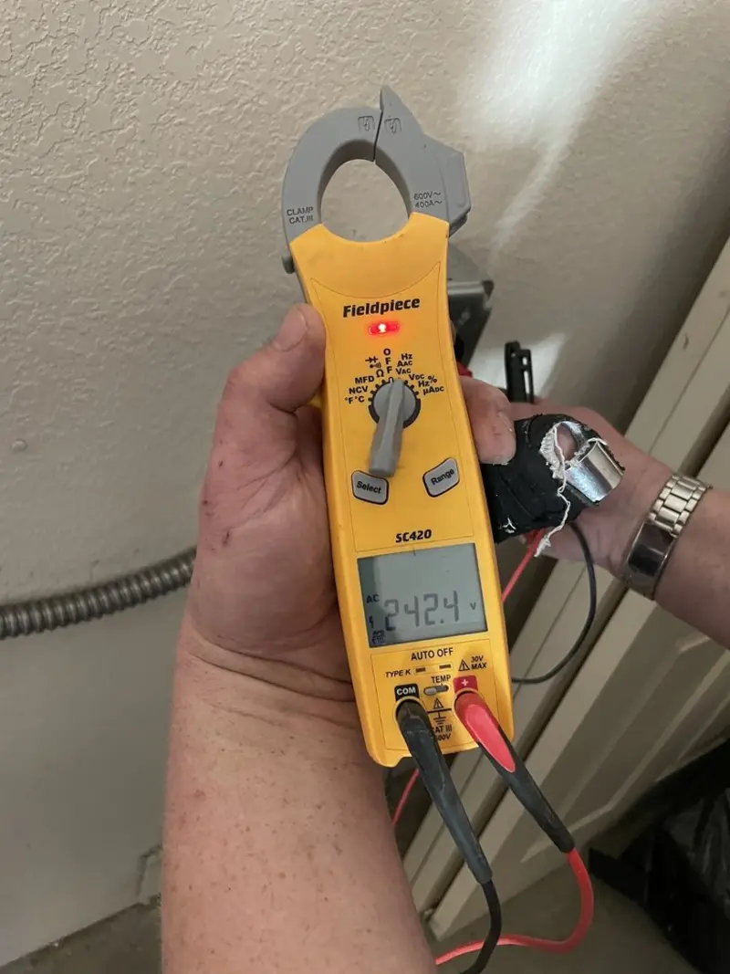 Voltage testing with clamp meter during Ceiling Fan Installation in Camp Swift